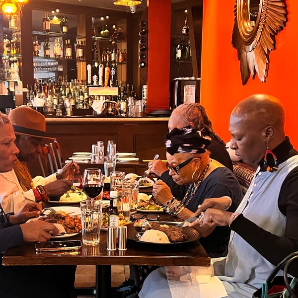 Diverse group of people enjoying Turkish cuisine at Deniz Mediterranean Turkish Cuisine restaurant.